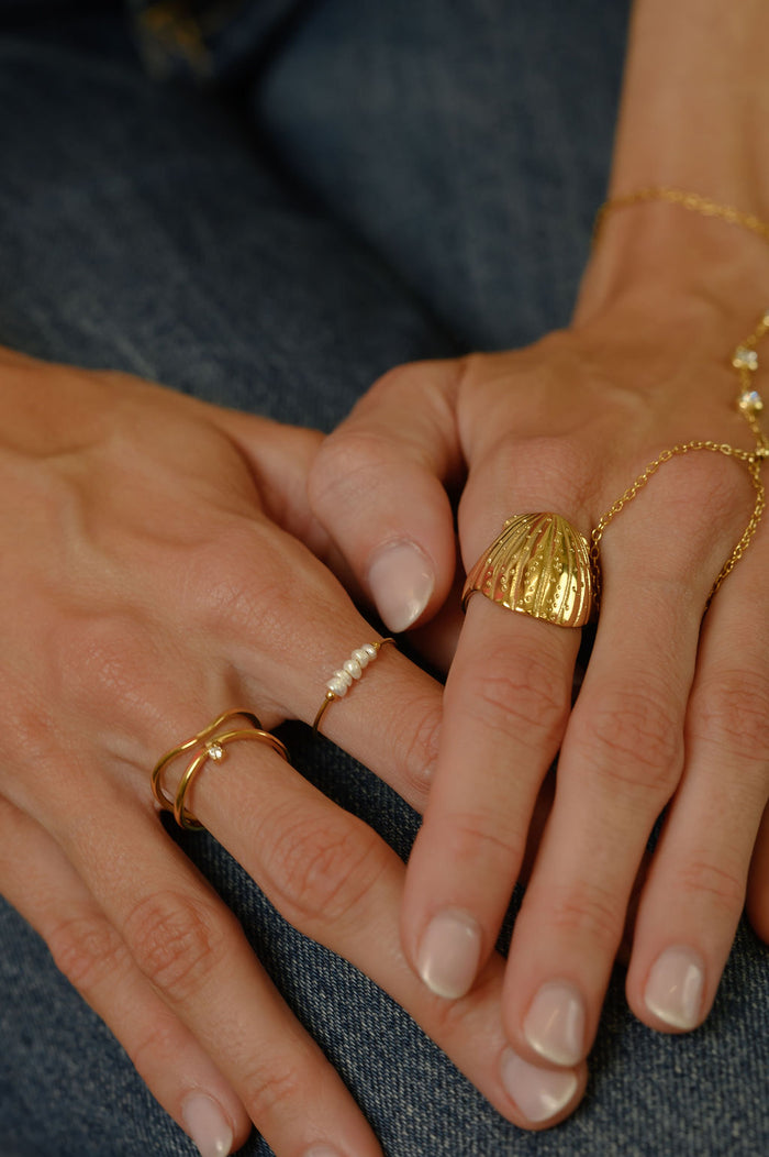 Close up of the gold Cinque Terre pearl ring by Beads by Tara on a white background