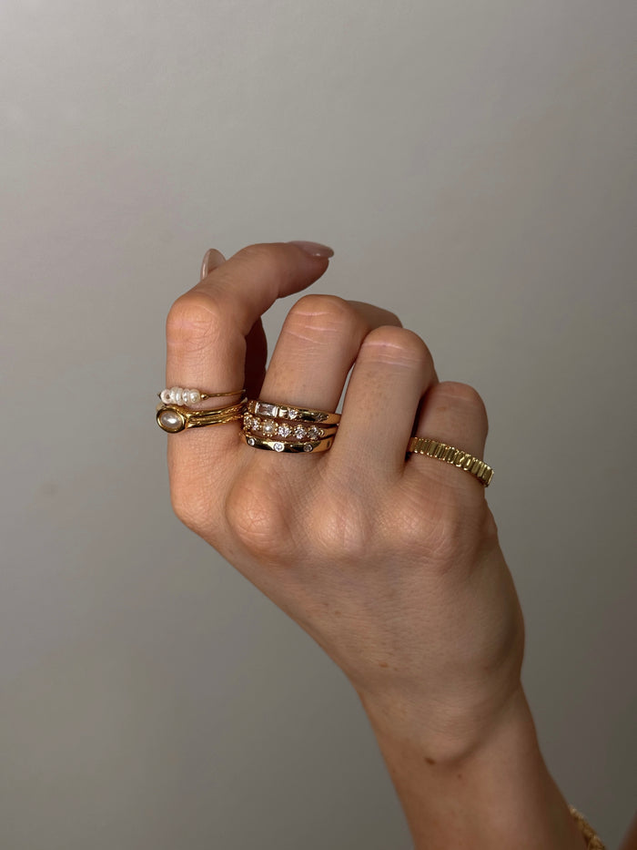 Close view of the gold Cinque Terre pearl ring on a white background