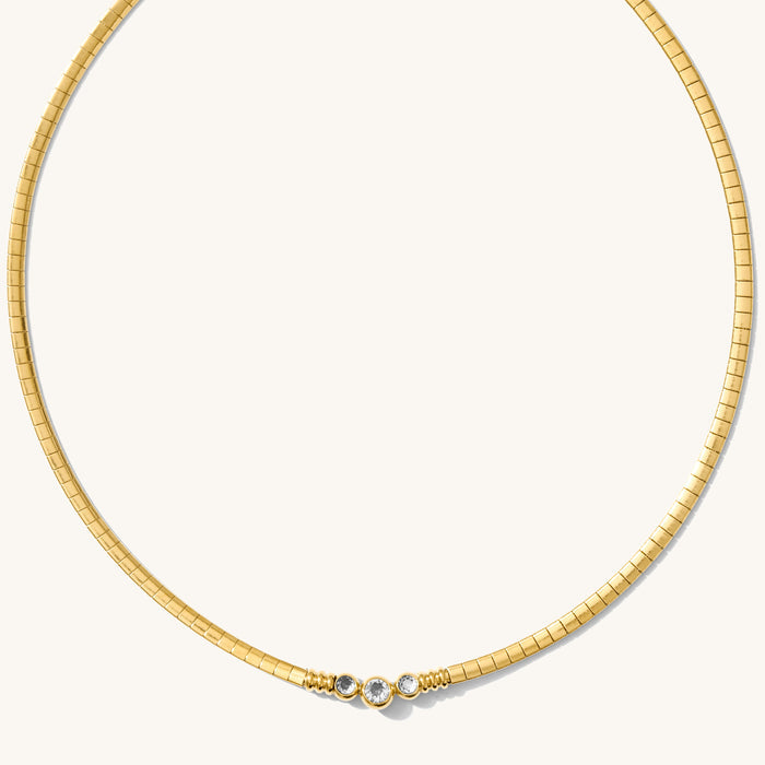 Close up of the gold Collins collar necklace on a white background