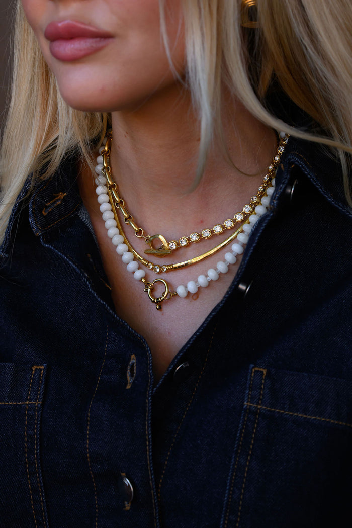 Three dainty center stones on the gold Collins collar necklace