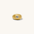 Close up of the gold Comet dome ring and its center stone on a white background