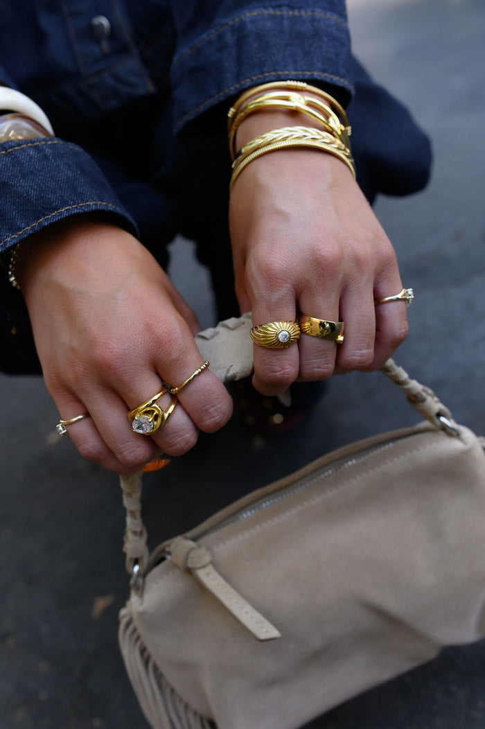 Gold Comet ring with rippling grooves that catch the light from every angle