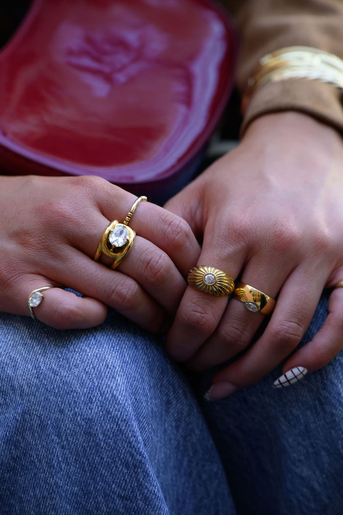 Gold Comet ring showing the ripple detail across its domed band