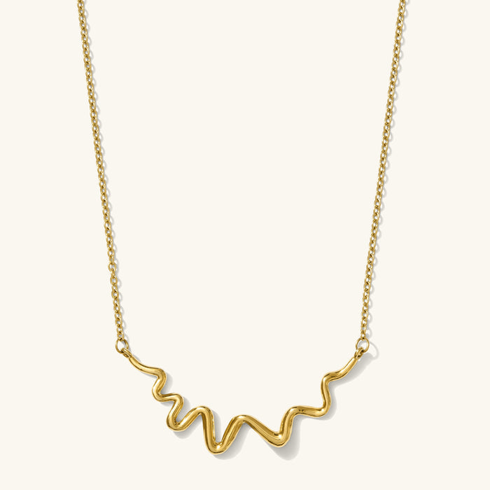 Sculptural gold Contour charm necklace with a curved, textured silhouette