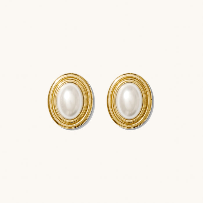 Close up of red and black accent earrings on a white background