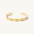 Gold textured cuff with flowers on a white background