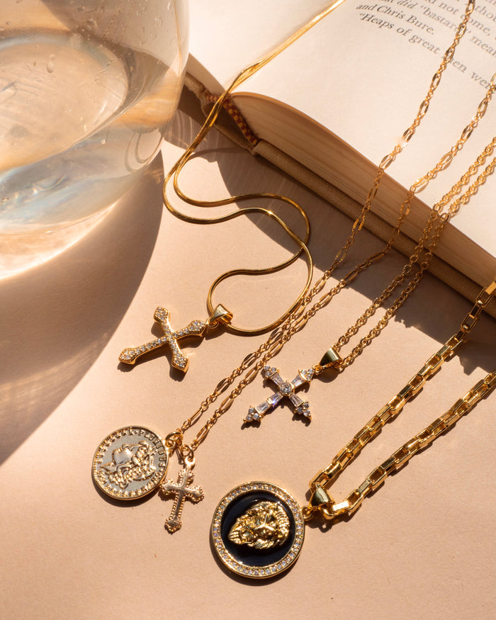 Close up of a neckline wearing the gold Desiree pendant necklace