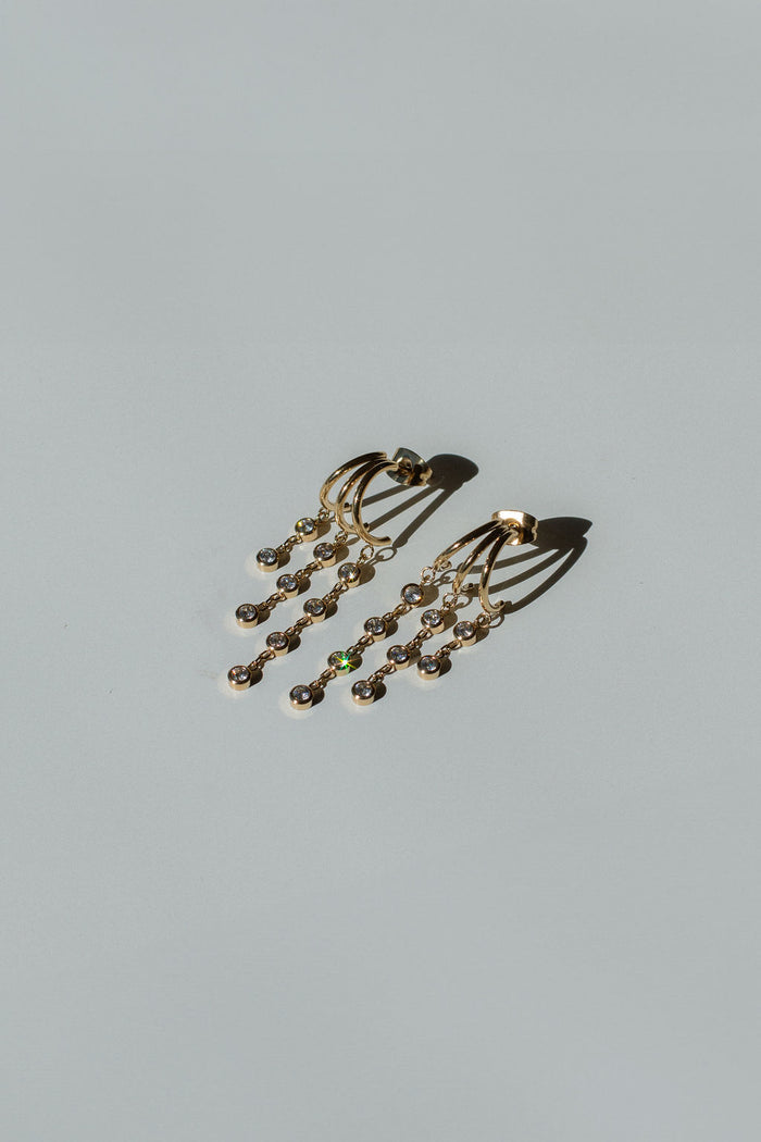 Close up shot of dangle earrings on a white background