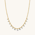 Close up of the gold Diamond Rain necklace on a white background