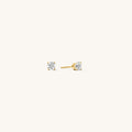 Close up of gold stone studs on a white background