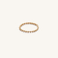 Close up of the gold Dottie chain ring on a white background