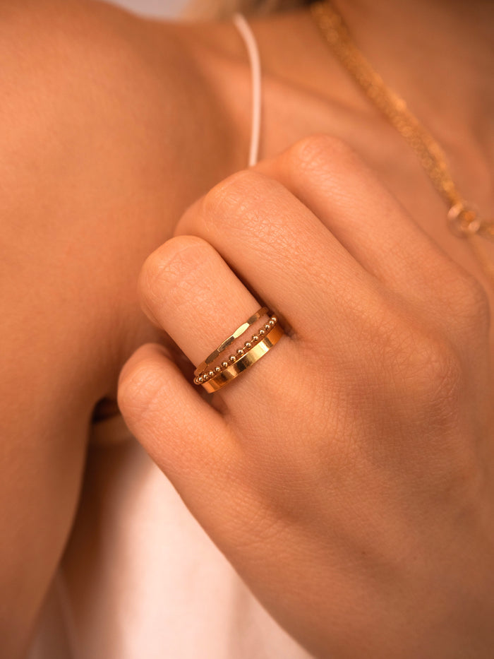 The Dottie chain ring worn stacked with thin gold-filled bands