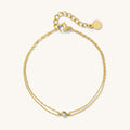 Close up of a gold bracelet on a white background
