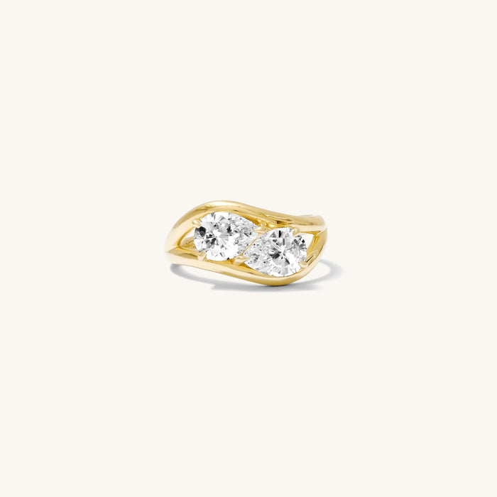 Close up of the gold Double Pear pinky ring on a white background