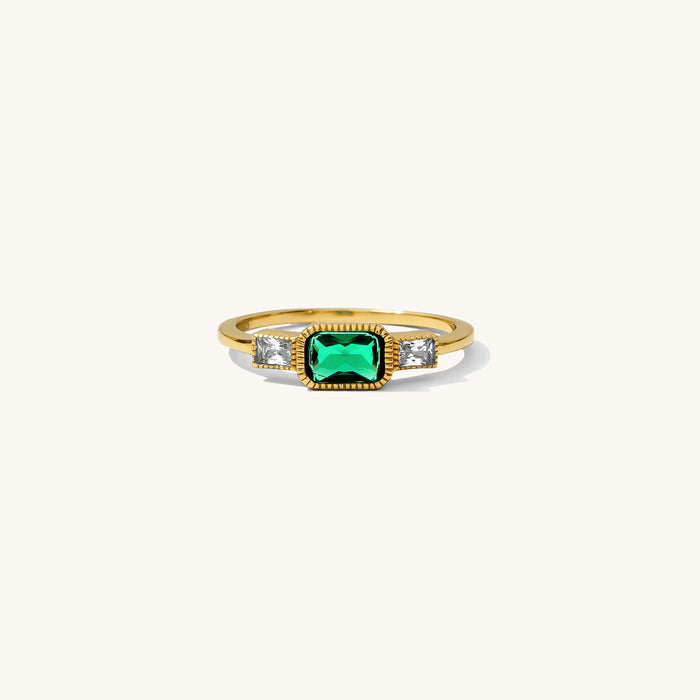 East West Emerald ring with a horizontal emerald stone in a textured bezel