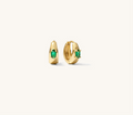 Close up of gold earrings on a white background