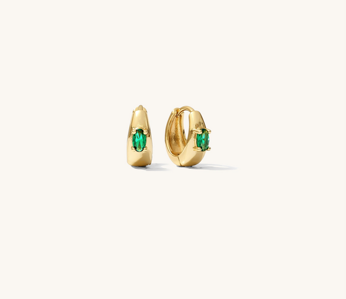 Close up of gold earrings on a white background