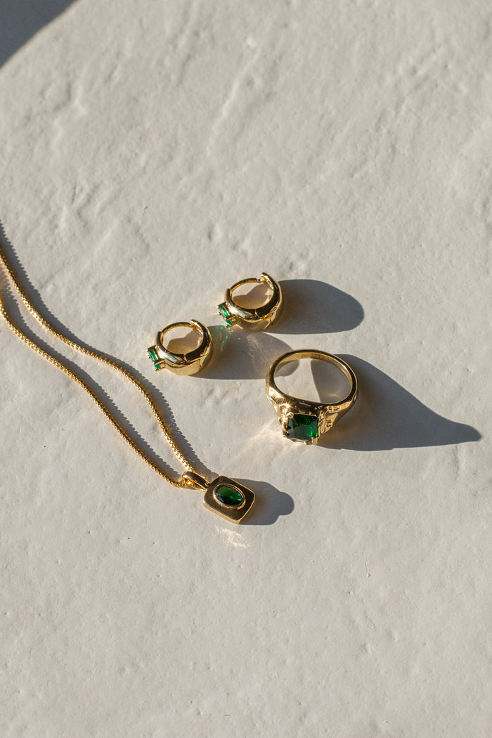 Gold jewelry on a white stone