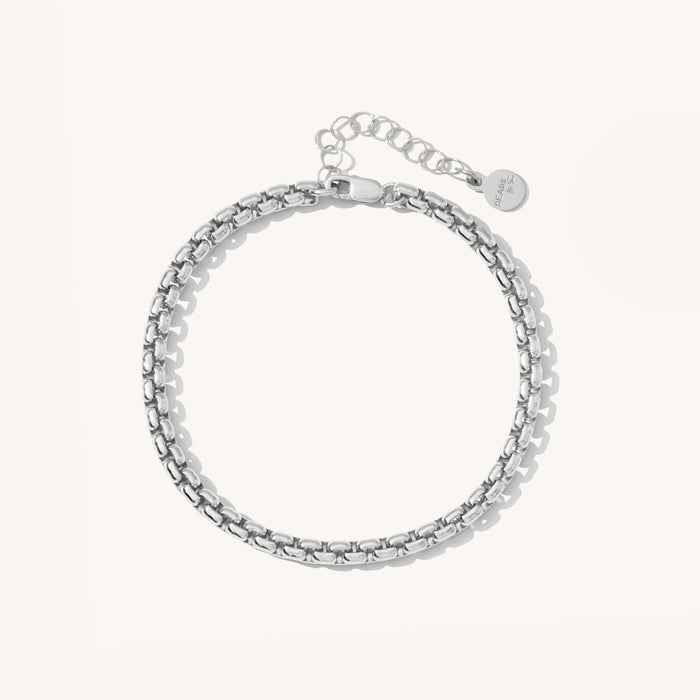 Close up of silver bracelet on a white background