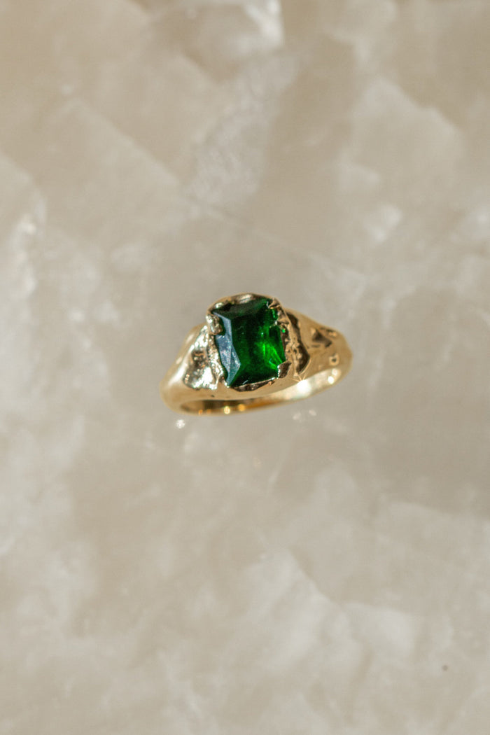 Close view of the emerald centerpiece on the gold Empress ring