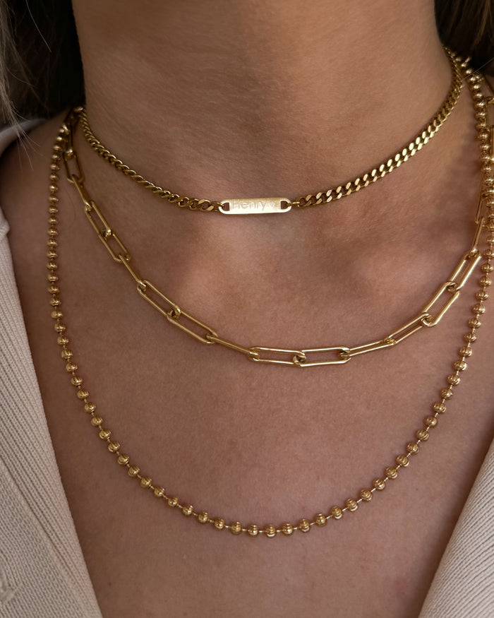 A detail view of the engraved Cuban bar necklace by Beads by Tara