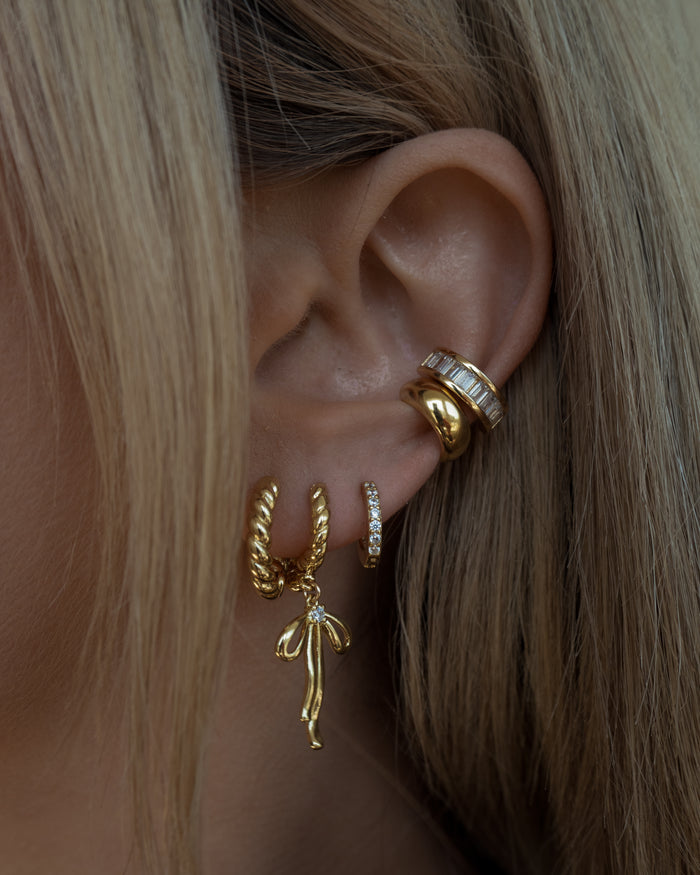 Model wearing the sparkling gold Eve ear cuff along the upper ear