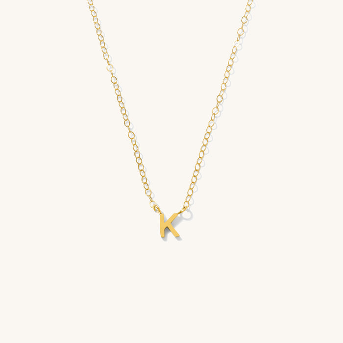 Detail view of the gold Everyday Initial necklace on a white background