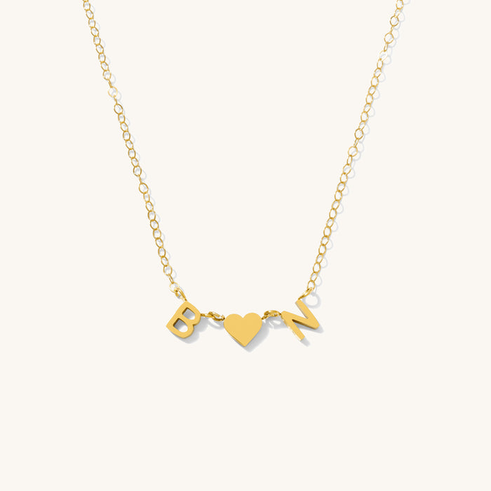 Studio close up of the gold Everyday Initial necklace on a white background