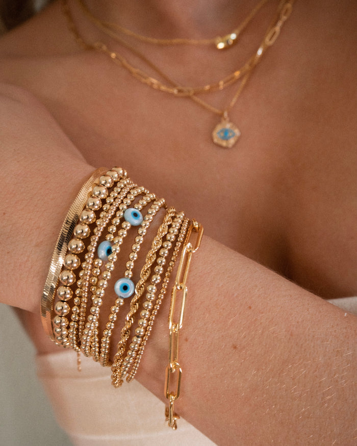 Gold bead bracelet with an evil eye accent for your everyday stack