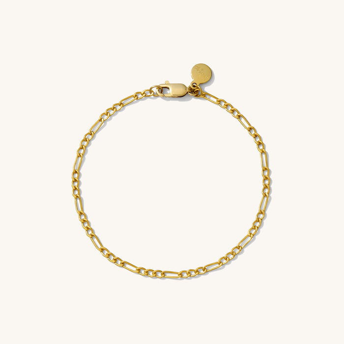 Close up of a gold chain bracelet on a white background
