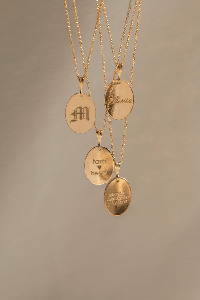 Fiona necklace with a smooth oval tag personalized with a name
