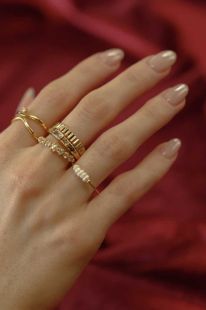 The gold Fleur de Sel pearl ring from Beads by Tara, shown on a white background