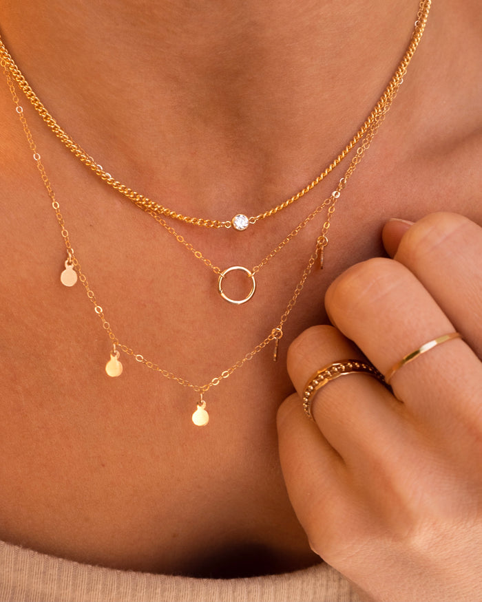 Close up of a neckline wearing the Full Circle pendant necklace