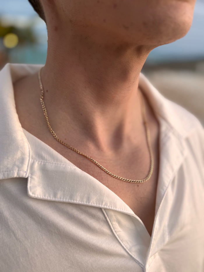 A detail view of the Garrett flat Cuban chain necklace by Beads by Tara