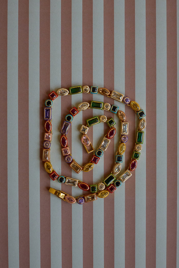 Colorful beaded necklace on a striped background