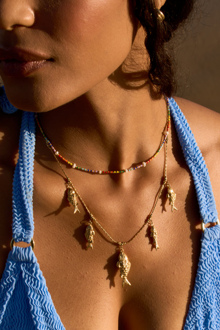 The gold Go Fish statement necklace, designed by Beads by Tara