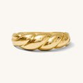 Close up of gold bangle bracelet on white background