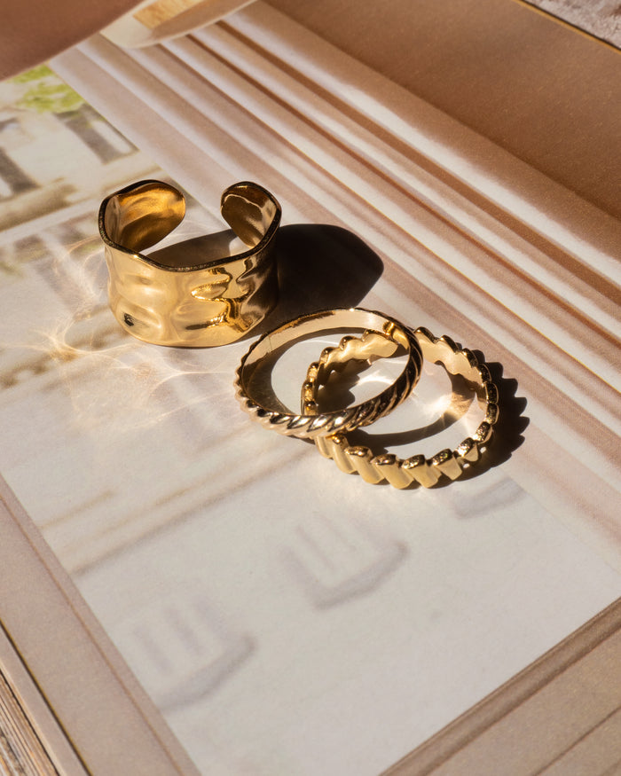 Model wearing the Goldie rope ring with other gold stacking rings