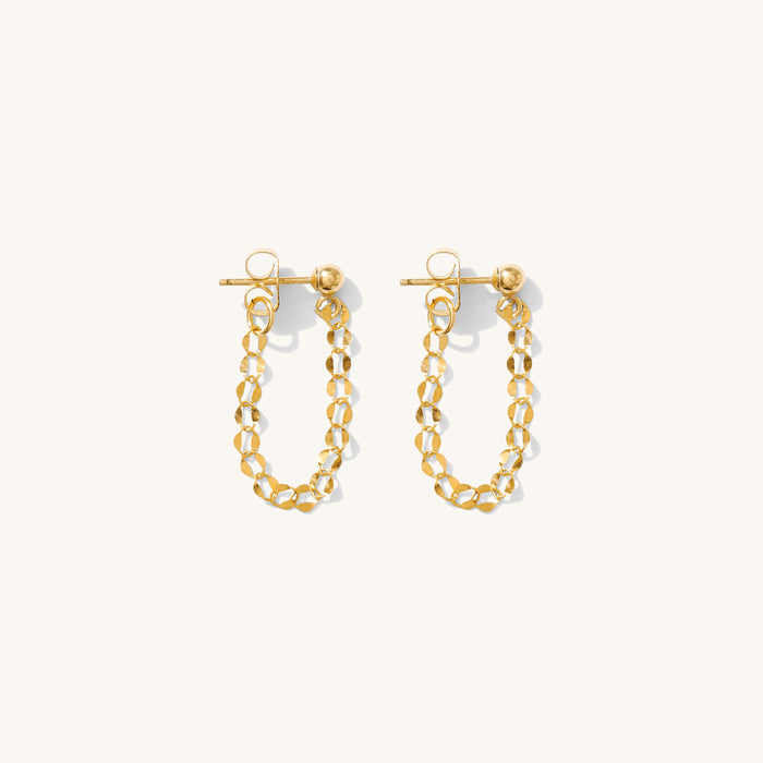 Close up of dangle earrings on a white background