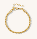 Close up of a gold bracelet on a white background