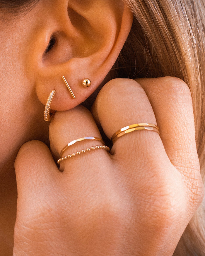 Close up of a hand wearing the Hammered ring in 14k gold fill