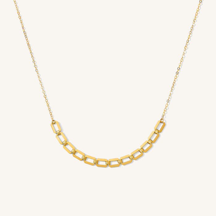 Close up of the gold Hannah flat chain necklace on a white background