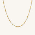 Close up of the gold Harley ball chain necklace on a white background