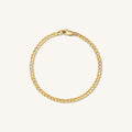 Close up of a gold curb link bracelet on a white background