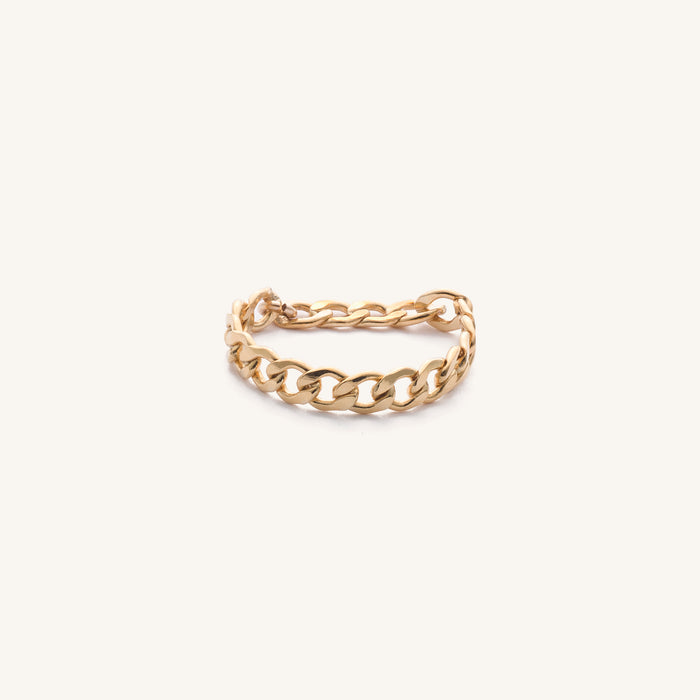 Close up of the gold Harper chain ring on a white background