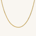 Close up of the gold Harper curb link chain necklace on a white background