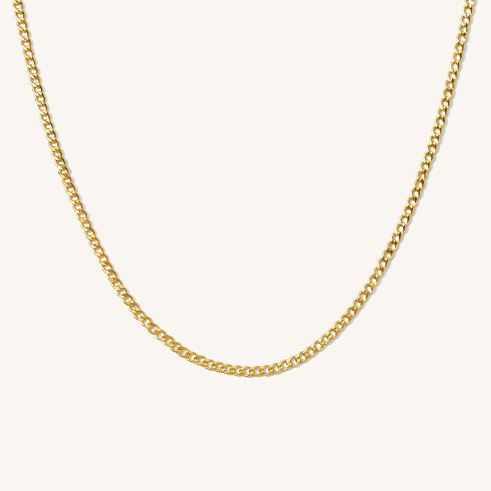 Close up of the gold Harper curb link chain necklace on a white background