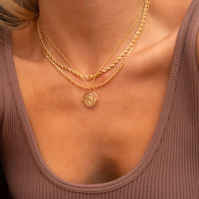 Gold Harper curb chain necklace worn layered