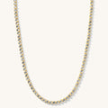 Close up of the gold Heirloom bezel tennis necklace on a white background