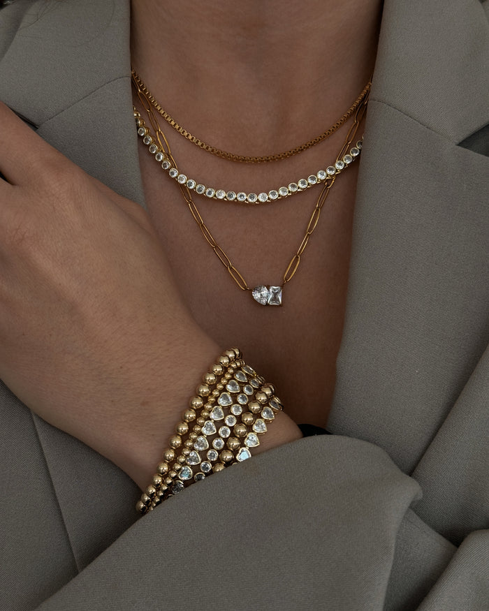 Model wearing the gold Heirloom bezel tennis necklace from Beads by Tara